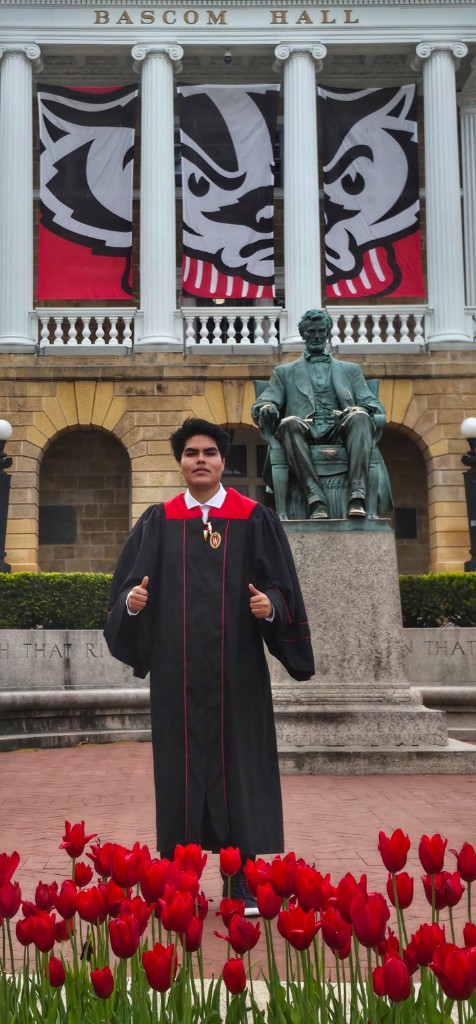 Franco Pastor in graduation regalia in front of Bascom Hall, University of Wisconsin-Madison